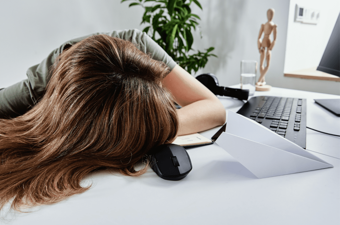 Burnout vrouw uitgeput op bureau